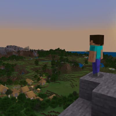 man tittar ut över en by i Minecraft