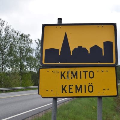 Svartgul vägskylt för tätort med texten Kimito, Kemiö.