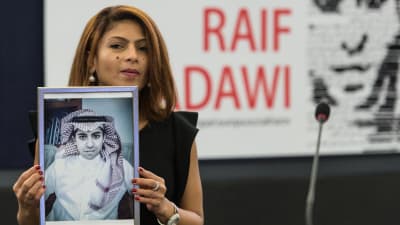Ensaf Haidar, wife of jailed Saudi blogger Raif Badawi, holds a picture of her husband in the European Parliament in Strasbourg
