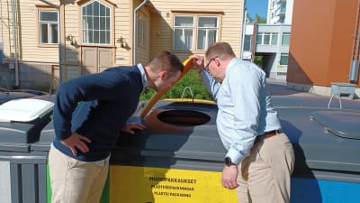 Voas vd Marko Ylimäki och fastighetsdirektör Teppo Rasku tittar in i ett sopkärl