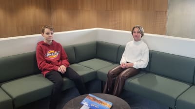 Två barn som sitter i en soffa. 