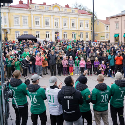 EIF-spelarna hyllas av människor på torget.