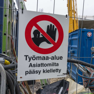 Konalaan valmistuvan Helsingin pelastuslaitoksen työmaa, talon runko pystyssä, etualalla työmaan aidassa kyltti Rakennustyömaa Asiattomilta pääsy kielletty.