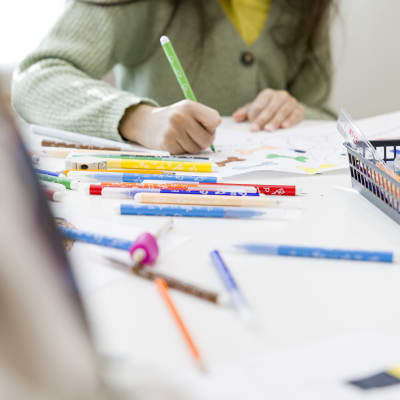 Oppilas värittää tussilla piirrustusta oppitunnilla.