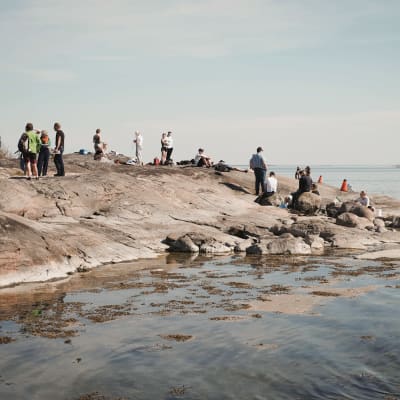 Lukiolaisia ja muita ihmisiä rantakalliolla Dalskär-saarella.