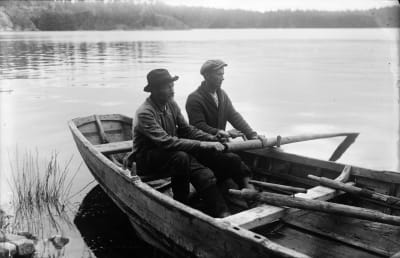 Två roddare i en kyrkbåt, bilden är tagen i början av 1900-talet.