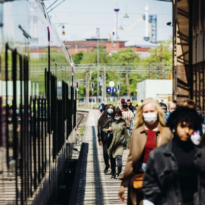 Matkustajia hengityssuojaimet kasvoilla Helsingin päärautatieasemalla 24. toukokuuta 2021.