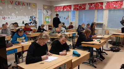 Ett klassrum med sjätteklassister som sitter och ritar.
