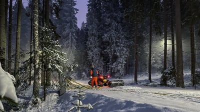 En man stampar snö i en skog med hjälp av en snöfräs. 