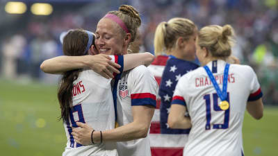Becky Sauerbrunn ler mot kramar om en lagkamrat och ler lyckligt.