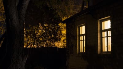 Upplysta fönster i hus på natten