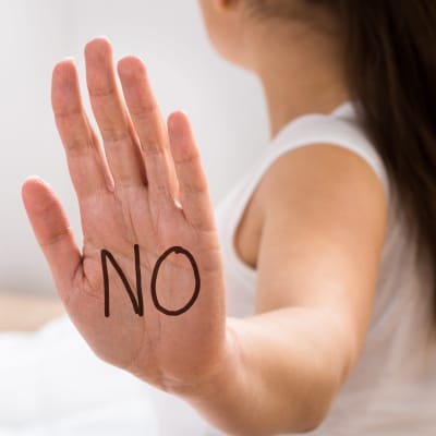 Women's  hand with the word 'No' written on the palm