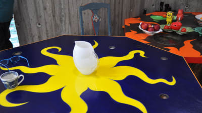Ett blått matbord med en en stor gul sol på.