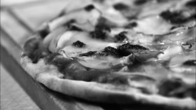 En svartvit bild på en pizza. 