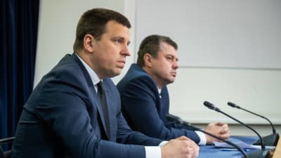 Estlands premiärminister Jüri Ratas och utrikesminister Urmas Reinsalu sitter vid ett bord med mikrofoner framför sig.