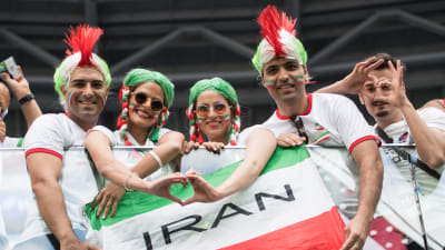 Iranska fotbolssupportrar gör hjärtan.