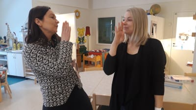 Angelica Storkamp och Alexandra Östergård visar tecknet för "ut".
