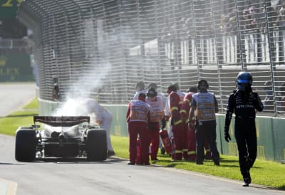 George Russell exits his smoking car.