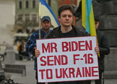 Ukrainska och belarusiska aktivister demonstrerade i Kraków, Polen, på fredagen. På det här plakatet uppmanas USA:s  president att skicka jaktplan till Ukraina. 