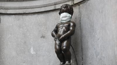 Manneken Pis, statyn som föreställer en liten kissande pojke och som blivit en symbol för Bryssel, har också försetts med ansiktsmask.