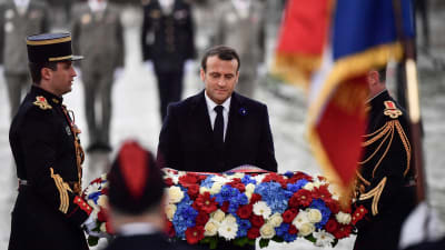 Frankrikes president Emmanuel Macron lägger en blomsterkrans på den okände soldatens grav under Triumfbågen.