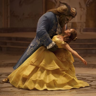 Skönheten Belle dansar i gul klänning tillsammans med Odjuret.