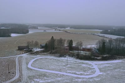 Drönarbild av Wahlrooska hästsportcenter i Korsholm som håller på att byggas vid en gammal gård med tillhörande åkrar.