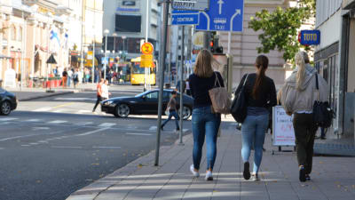 Ryggtavlan av tre unga kvinnor i Åbo centrum.