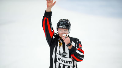 Jarno Heikkinen håller ett papper för munnen