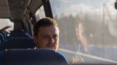en man sitter i bussen