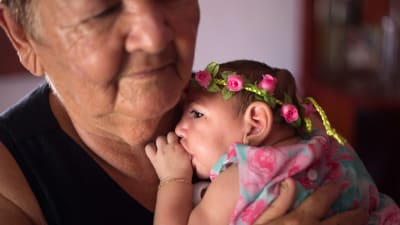 Ana Beatriz, en liten brasiliansk flicka som lider av mikrocefali med blomkrans på huvudet.