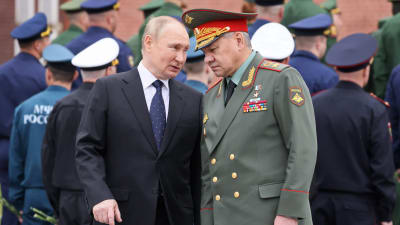 Rysslands president Vladimir Putin talar med den ryska försvarsministern Sergej Shojgu under en ceremoni i Moskva den 22 juni 2022 till minnet av de som dog i andra världskriget. 