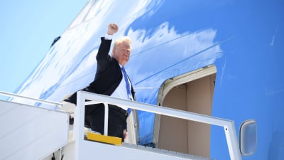 Donald Trump med knuten näve stiger in i flygplan på väg från Kanada