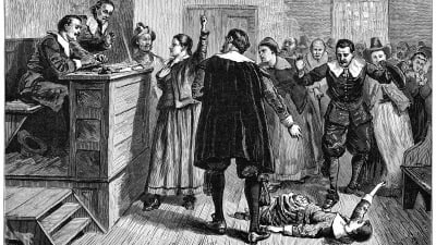 Piirroskuvassa on oikeudenkäynti noidaksi syytettyä naista vastaan, nainen makaa lattialla, väkijoukko huutaa. Piirron on vuodelta 1897.