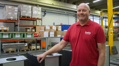 En man står vid en rad bastuugnar i en fabrik