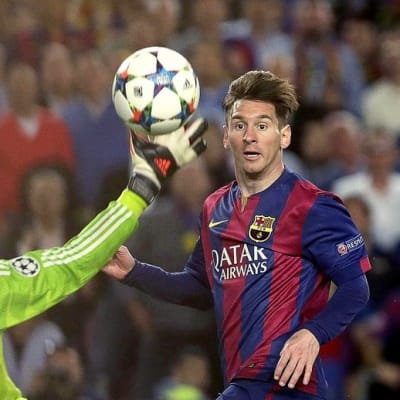 Barcelonan Lionel Messi nostaa pallon ohi Bayern Münchenin Manuel Neuerin.