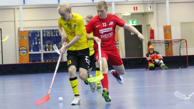 Knights Roni Saarinen (gul skjorta) med bollen, attackeras av MODO:s Jouni Kotilainen.