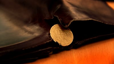 Ett grekiskt euromynt i en sliten plånbok