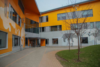 Ingången till en skola med färgrann fasad.