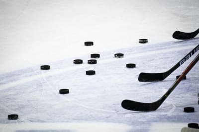 Puckar och ishockeyklubbor.