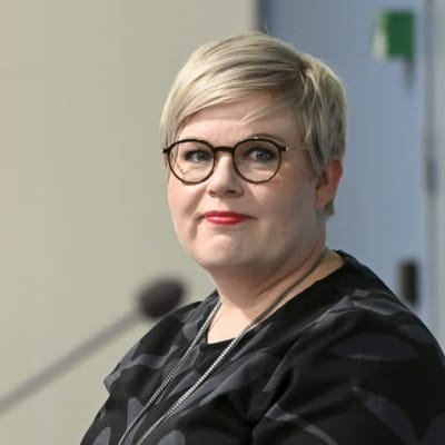 Annika Saarikko framför en talarstol.