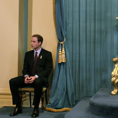 Prinssi William istuu kulltaun valtaistuimen vieressä.