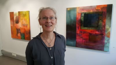 Margareta von Bonsdorff mellan sina målningar Purkautumaton jännite och Allting förändras på Galleri Bronda 2016.