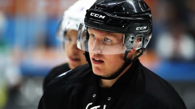 Närbild på Patrik Laine på hockeyträning i svart hjälm.