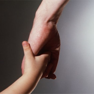AIkuinen ja lapsi käsi kädessä
