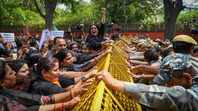 Kvinnor som stöder det indiska regeringspartiet BJP protesterar våldsamt mot ett staket polisen i Delhi har satt upp.