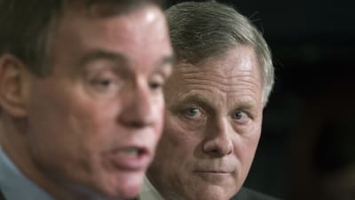 Richard Burr, den republikanska ordföranden för senatens underrättelseutksott ser på medan den demokratiska vice-ordföranden Mark Warner berättar om den pågående utredningen om Trump