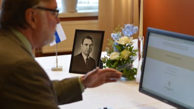 Åbos fullmäktigeordförande Seppo Lehtinen tecknar sitt namn i Mauno Koivistos kondoleansbok.
