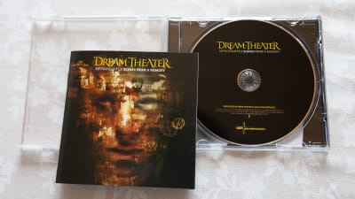 En CD-skiva med gruppen Dream Theater ligger på ett bord.