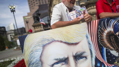 Trump-anhängare med plakat av sin presidentkandidat i Cleveland, Ohio den 17 juli 2016.